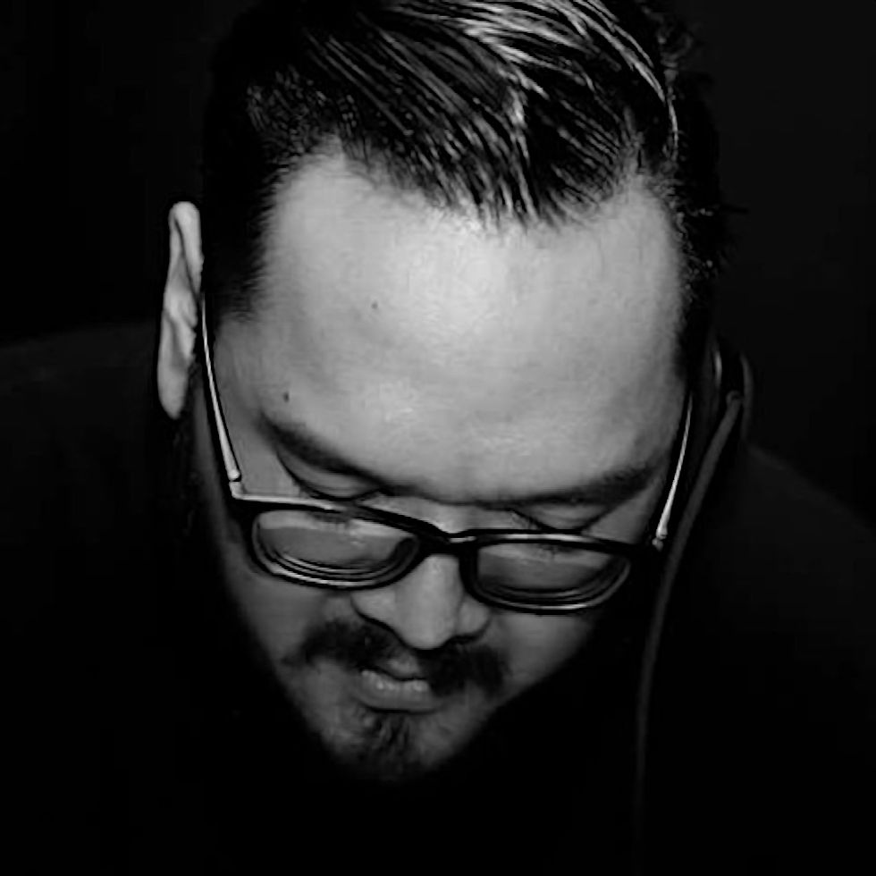 Indonesian DJ and producer Yorri standing looking down black and white image of his head.