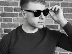 Music producer and DJ Al Park posing for a black and white promotional portrait.