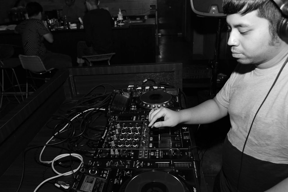 Indonesian DJ and producer Nandi performing at event in Jakarta, black and white image.