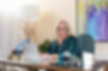 Dr. Kimberly Harrison sitting on her office typing on her laptop.
