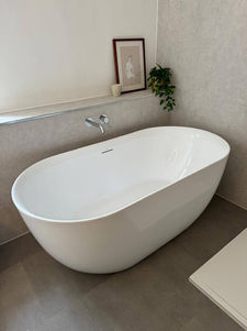A gorgeous natural stone bathroom with double ended bathtub. Guildford bathrooms