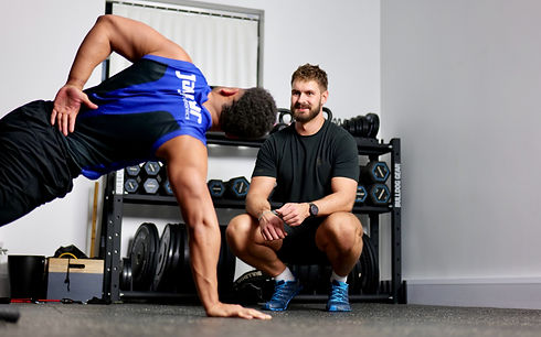 Shoulder physiotherapist Sam Baines with client during in-person coached rehab session