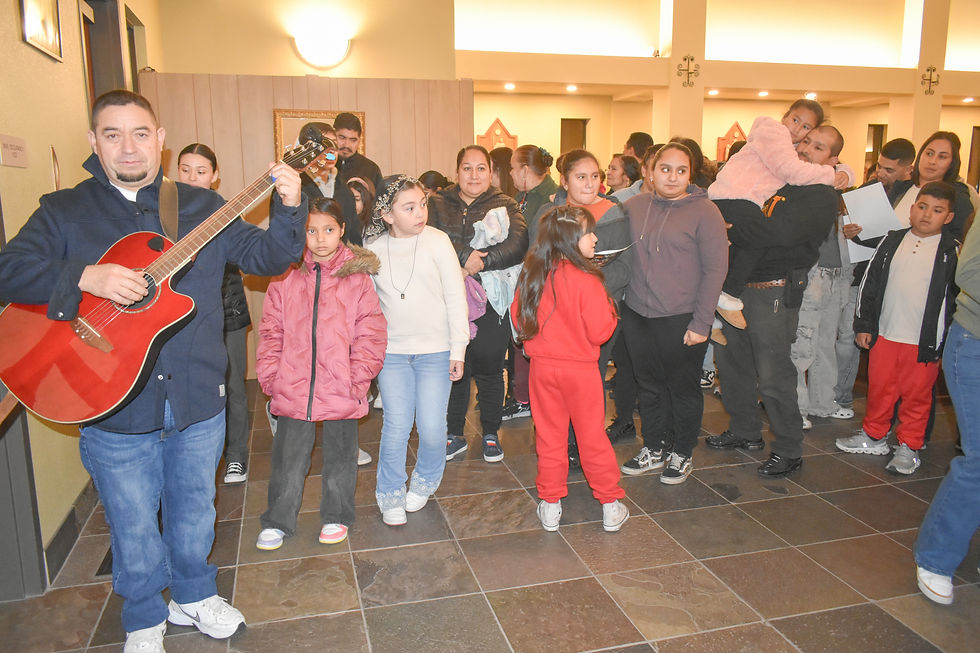Members of the Hispanic community participate in a traditional posada, reenacting Mary and Joseph' search for shelter as part of their spiritual preparation for Christmas