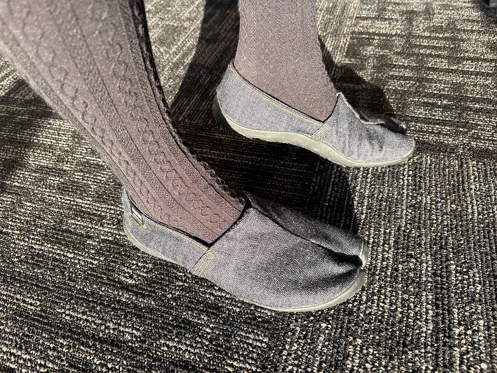 Super adorable split toe denim slip-on shoes, worn by a great pair of legs in black cabled tights.