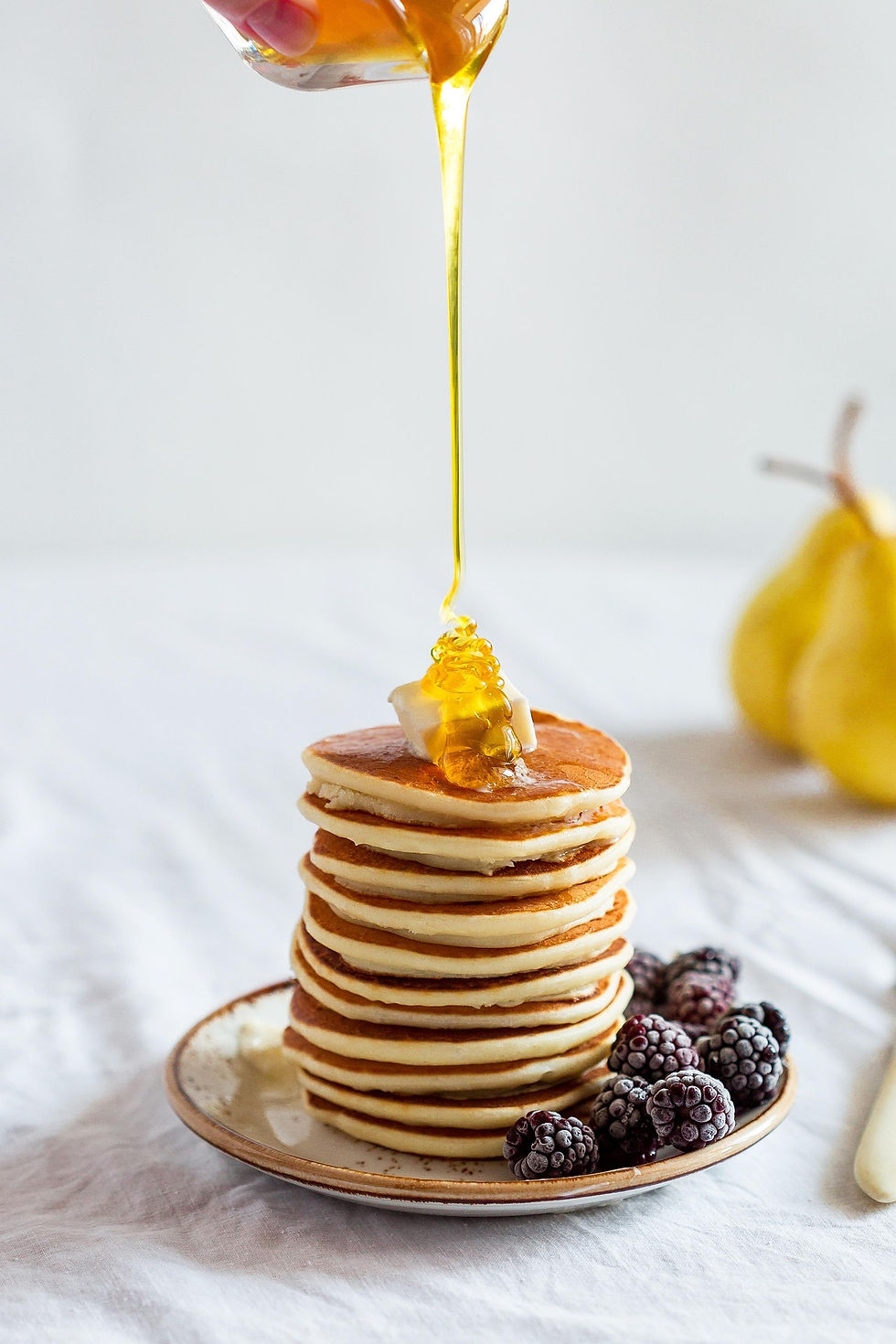 Drizzling Honey over Pancakes in Food Photography