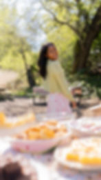 girl standing in front of picnic table