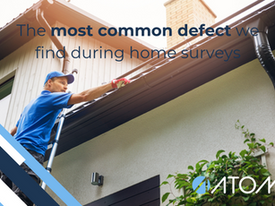 A tradesman clearing a blocked gutter