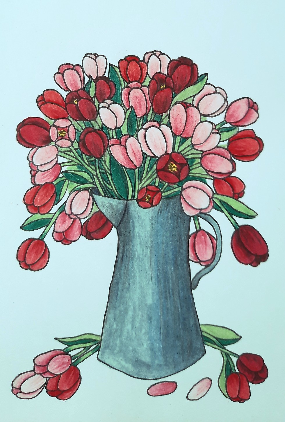 Bouquet of red and pink tulip flowers in a blue pitcher.
