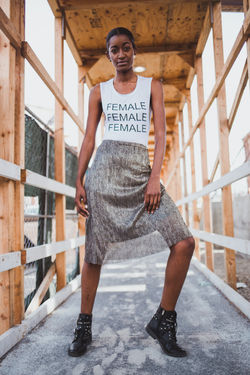 Girl modeling at construction site