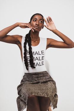 Girl wearing shirt that says female modeling with open arm gestures