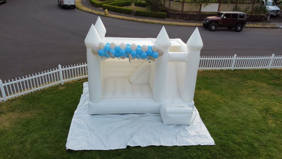 White bounce house with balloon accent