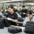 Quality control specialists inspecting finished handbags for product excellence