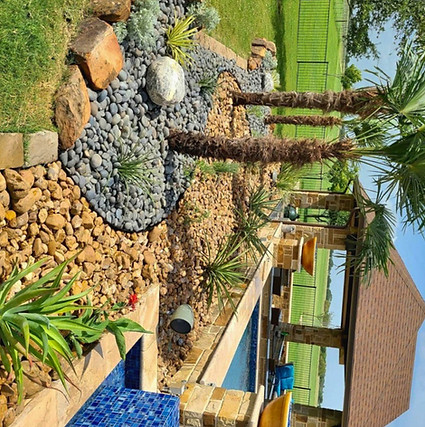 Southwestern-style landscape at a ranch home on FM 47 in Wills Point, TX, featuring contrasting decorative rocks in the garden beds.