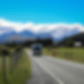 a campervan driving on a road in beautiful scenary in new zealand.jpg