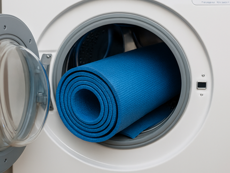 A blue yoga mat laying inside a washing machine.