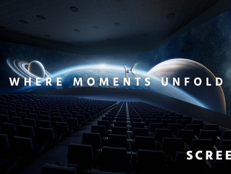 Immersive SCREENX cinema auditorium with a panoramic 270-degree view of outer space projected across the walls, showcasing the tagline “Where Moments Unfold.”