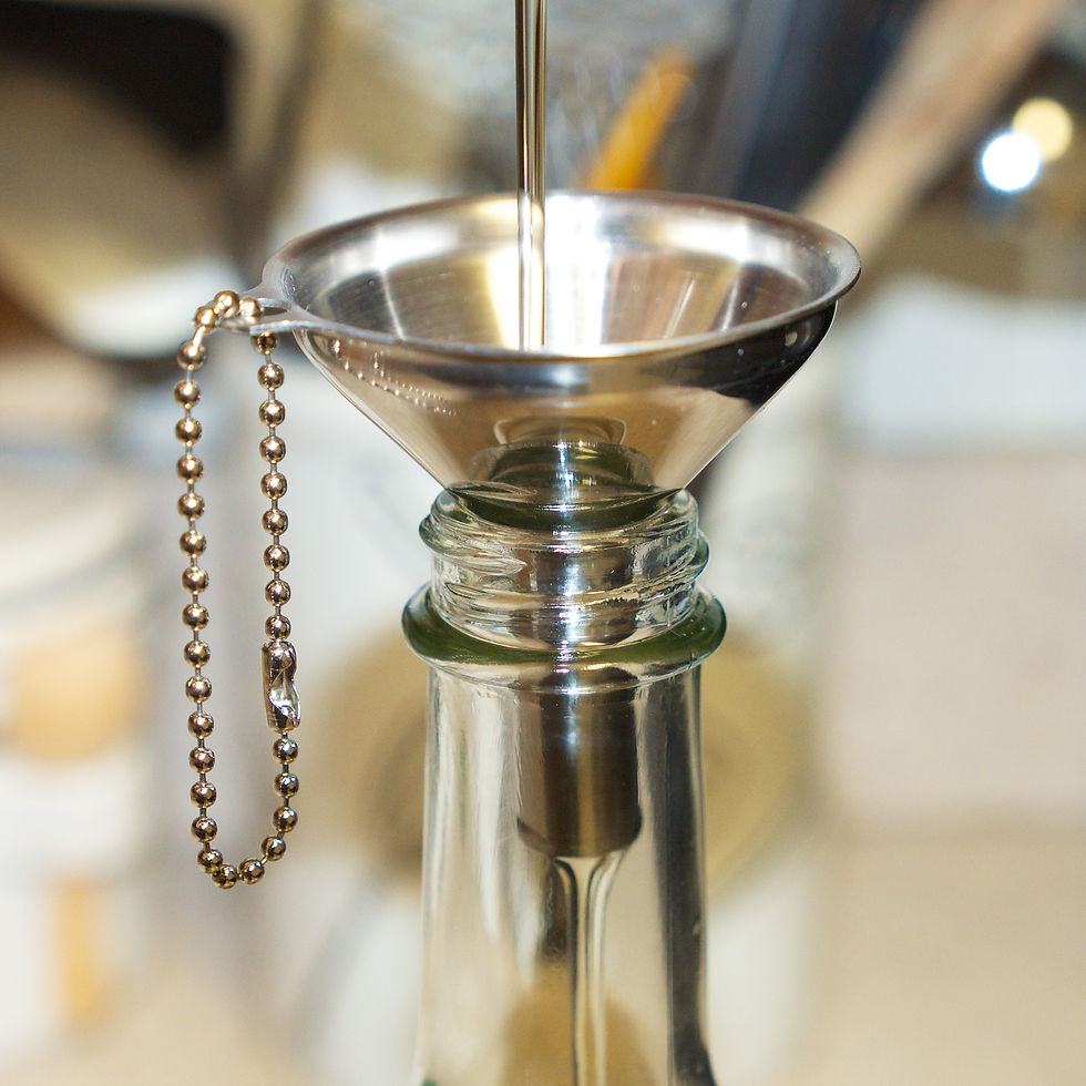 stainless steel funnel used for pouring oil into a jar