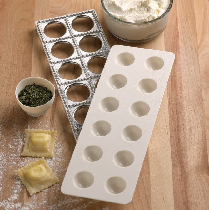 Ravioli Maker on counter with seasoning and flour - Fox Run 57665