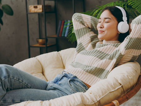 A woman relaxing with headphones on.