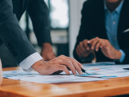 People in a business meeting reviewing paperwork.