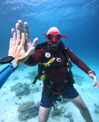 Diver giving a high five underwater