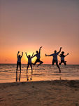 People jumping on the beach at sunset in Egypt