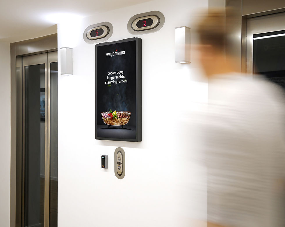 A man walking past a Wagamama ad
