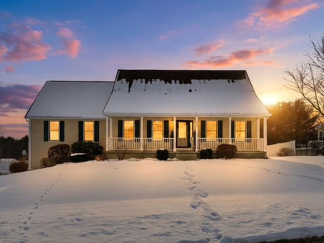 Twilight exterior photo of single-family home in Westfield MA with snow-covered yard and warm interior lighting.