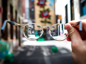 Wire frame eyeglasses on cityscape