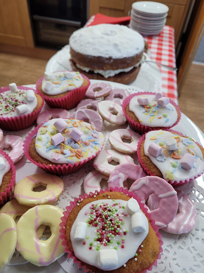 photo of cupcakes, a victoria sponge and biscuits.