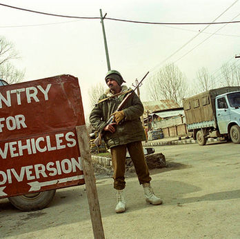 Soldier standing beside a roadblock during the 2004 ceasefire in Kashmir, India