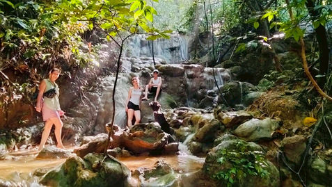 Jungle trekking adventure through rainforest streams and hidden waterfalls in Khao Sok National Park.