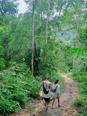 Visitors walking along a forest trail in the 500 Rai Inner Lake area