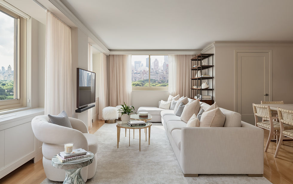 Upper West Side residence living room with Central Park views, sheer curtains, and expansive sectional sofa.