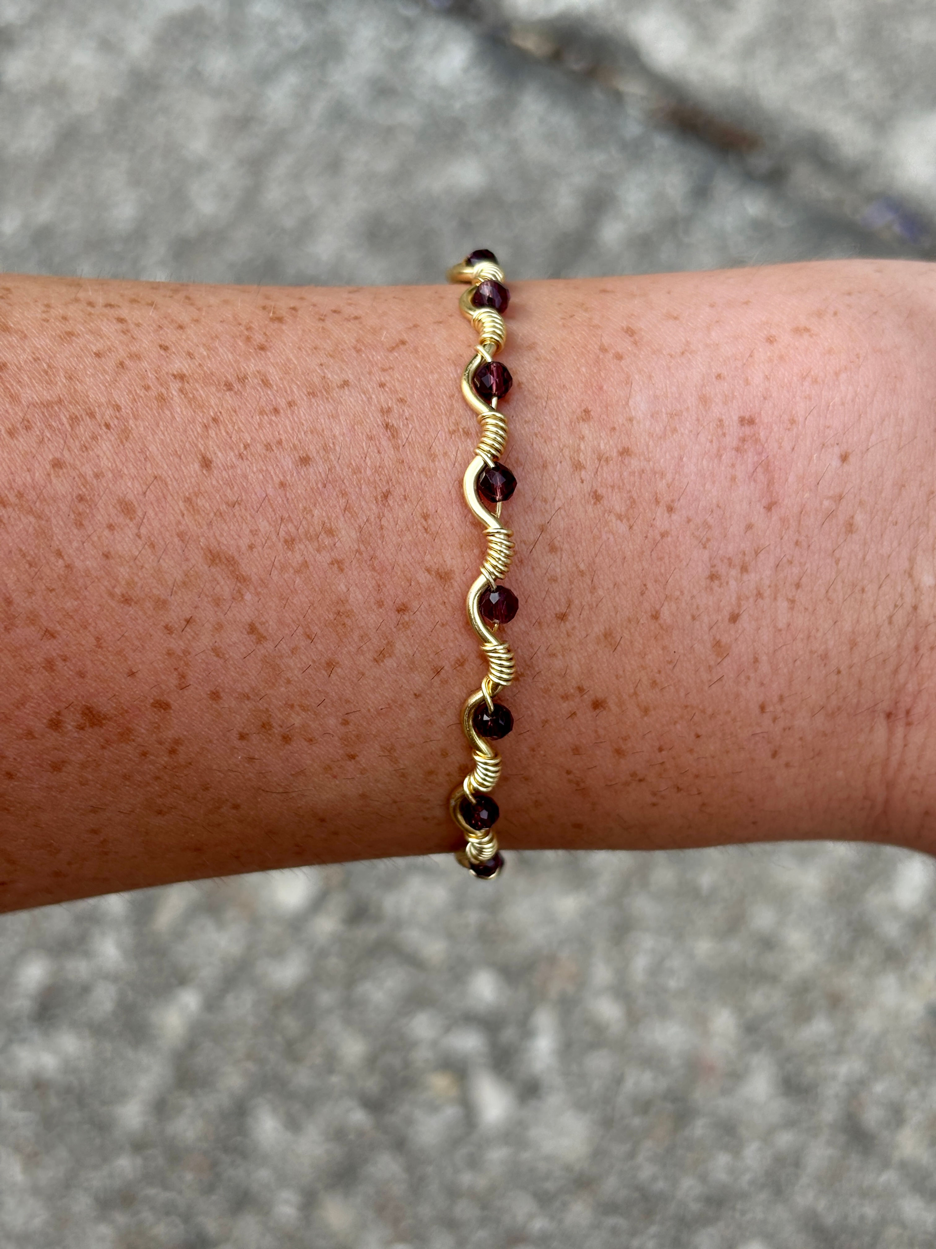 Garnet Paloma Bracelet on a freckled wrist