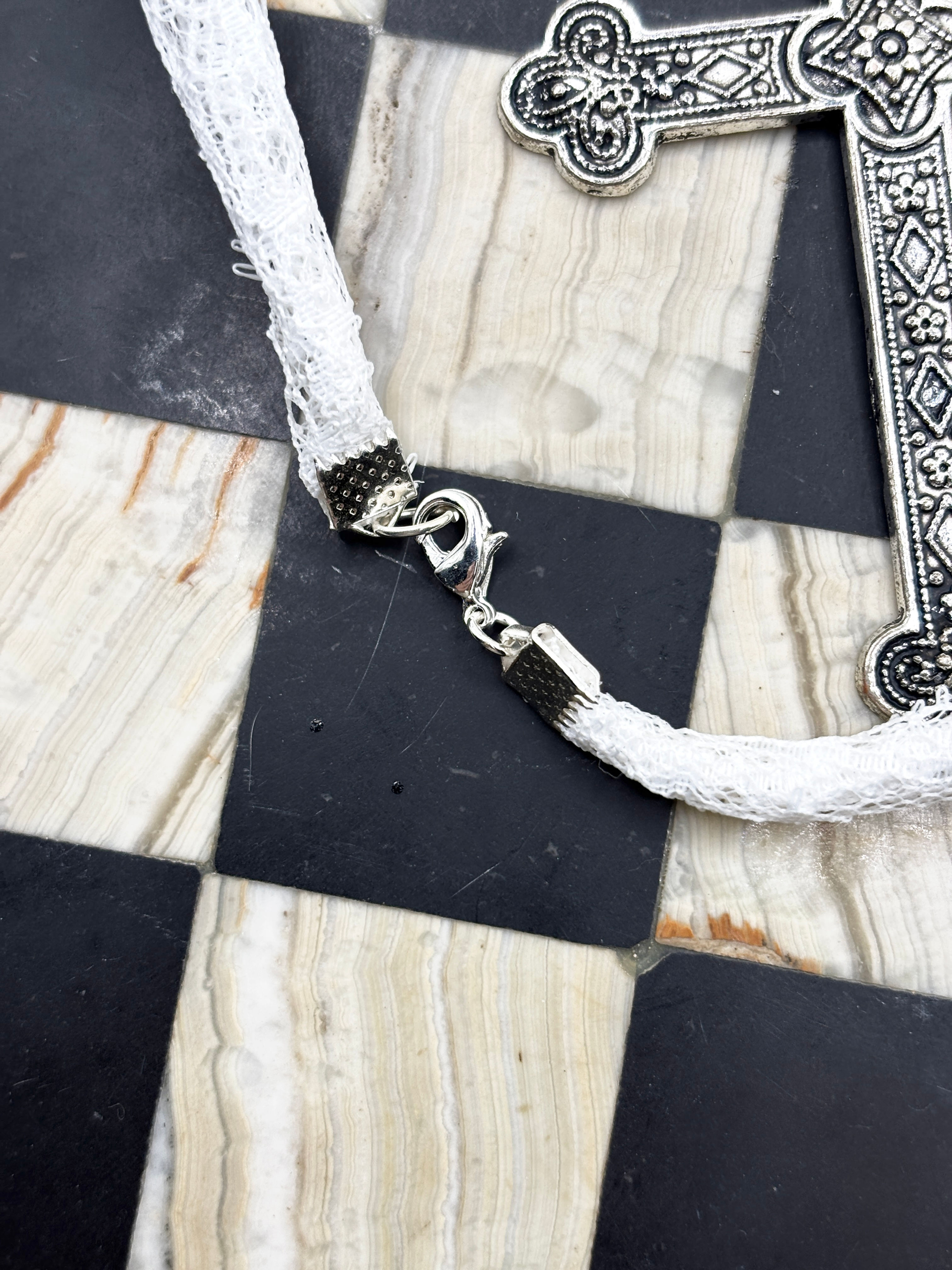 Clasp detail of the silver iris cross necklace