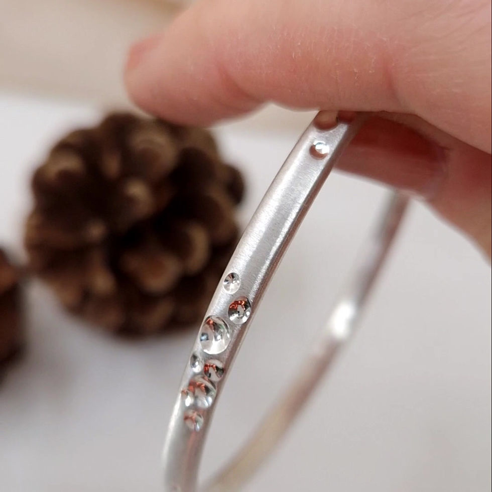 Thumbnail: Handmade sterling silver bangle with textured detail