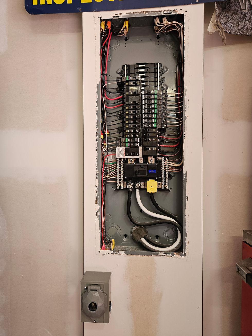 Open electrical panel with circuit breakers and wiring