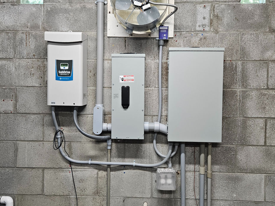 Industrial electrical panels and ventilation fan on wall