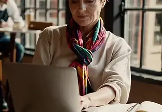 Woman at computer in cafe