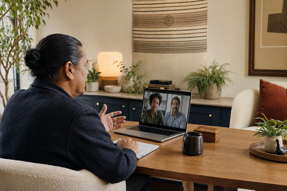 Man on a video call with two colleagues via laptop.