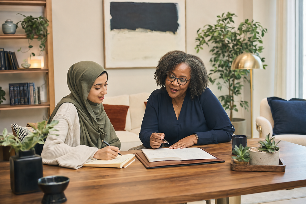 Two women in a meeting reviewing notes in a home office.