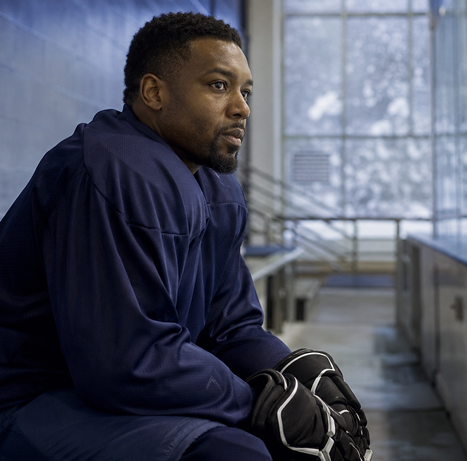 Focused athlete on a bench needing therapy for athletes.