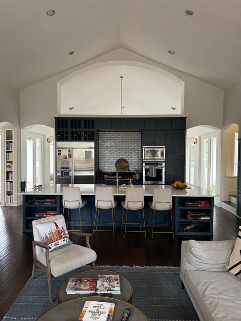 eat in kitchen with blue cabinets and white stools