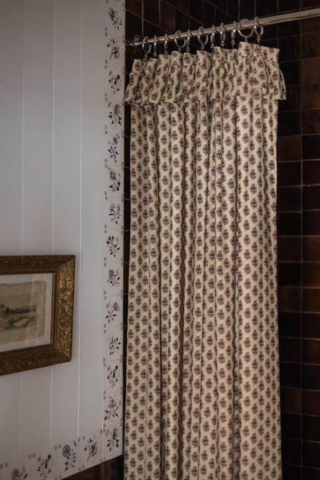 Burgundy zellige tile shower with hand-painted delft border tiles in Garden Home bathroom renovation.