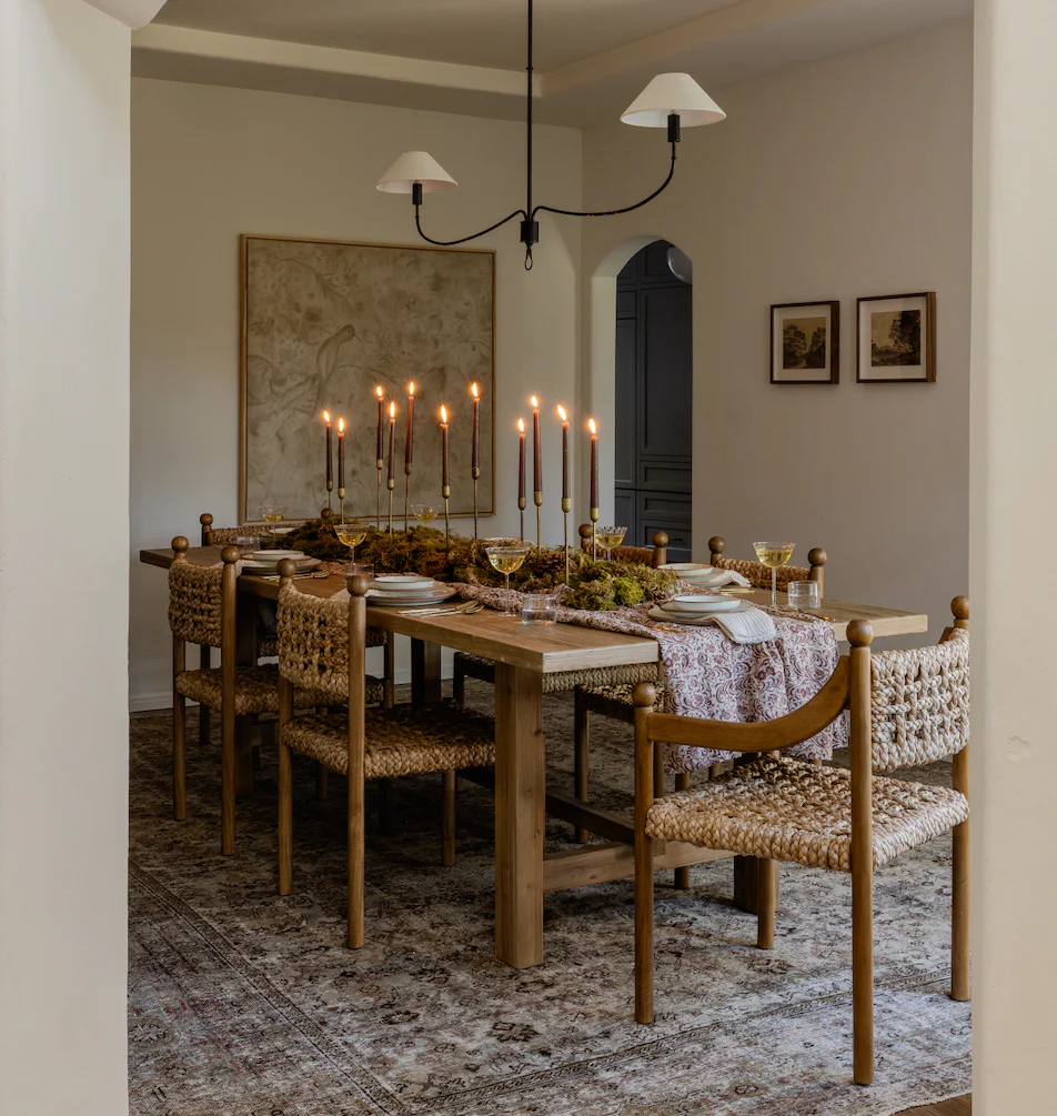 dining table with taper candles and neutral place settings