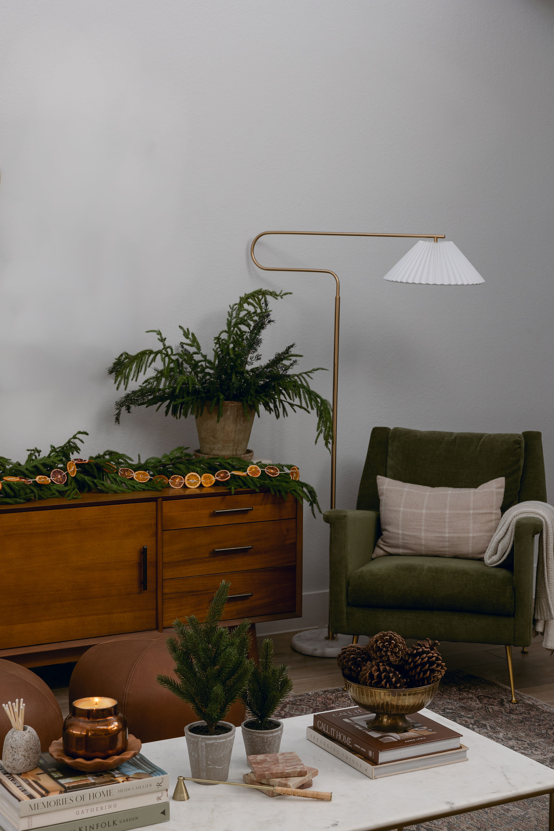 cozy living room with armchair and seasonal firs in a vase