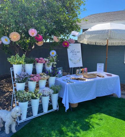 Baby shower guests arranging personalized floral bouquets