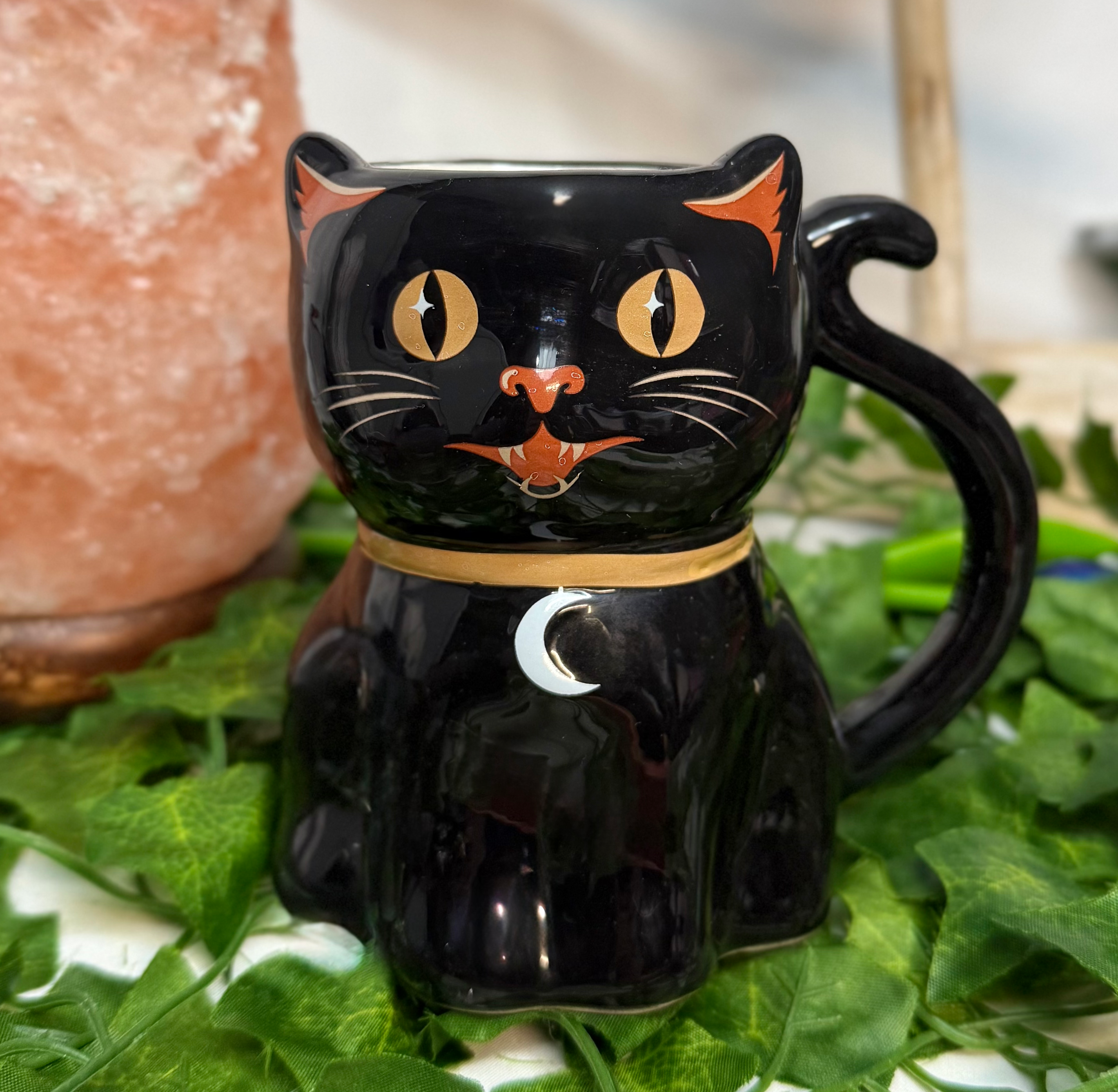 Black cat shaped mug with its tail as the handle