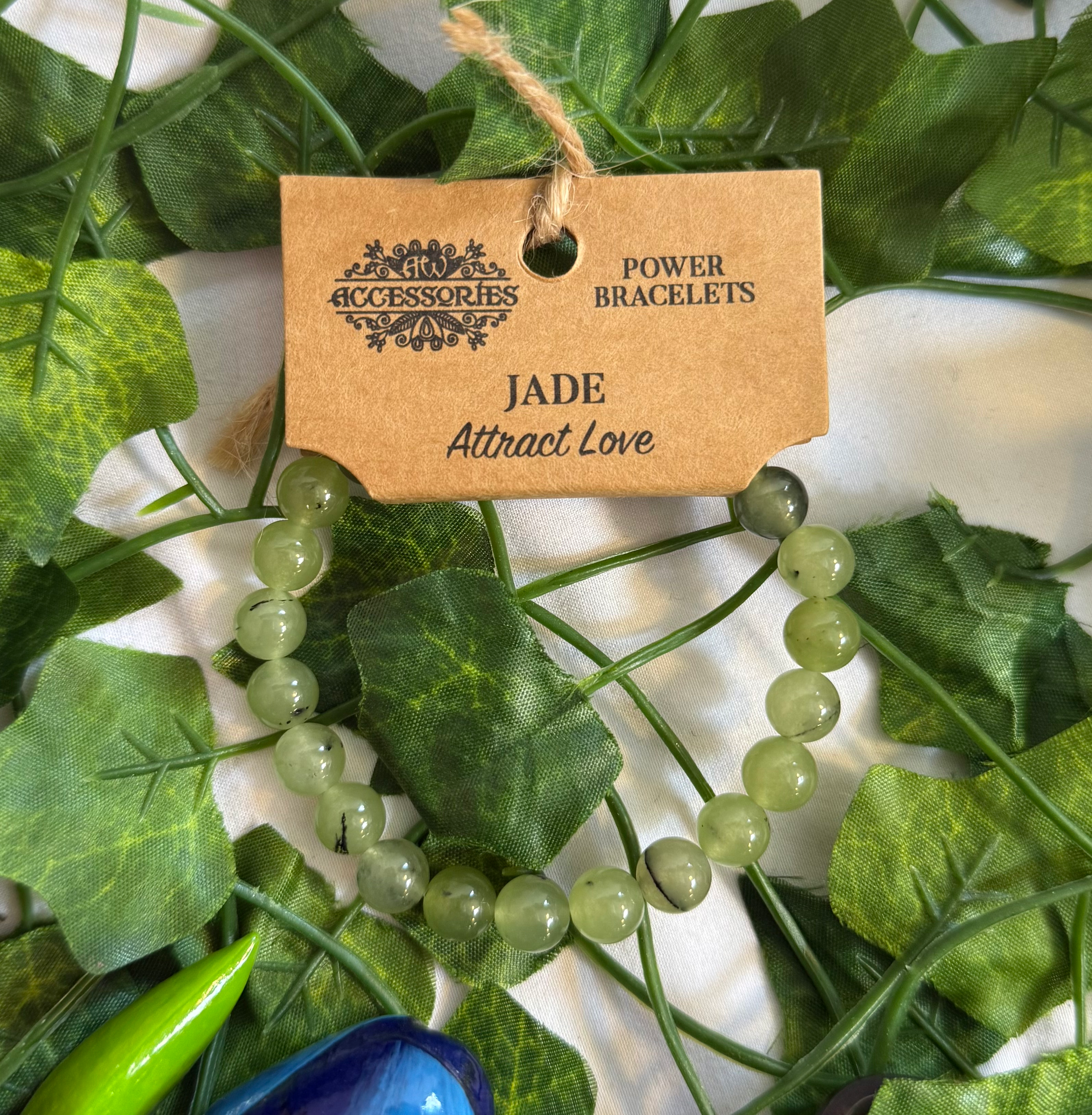 Jade Power Bracelet on a cardboard tag with Vines in the Background 
